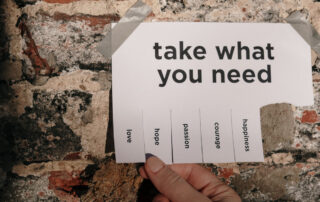 Image of a paper with "Take what you need" listed and tabs for love, hope, courage, etc.